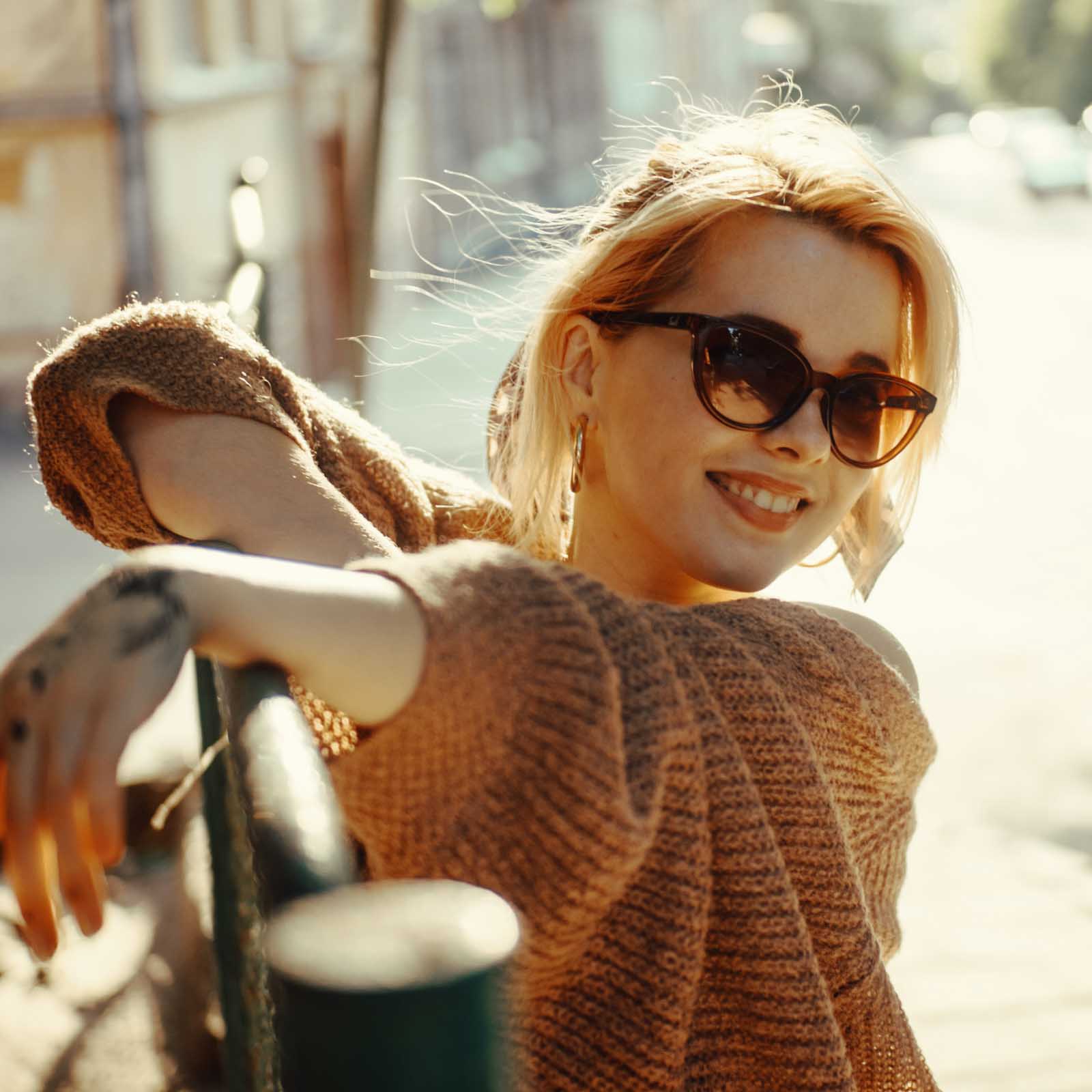 A lady wears our Parisian sunglasses on a sunny day in paris
