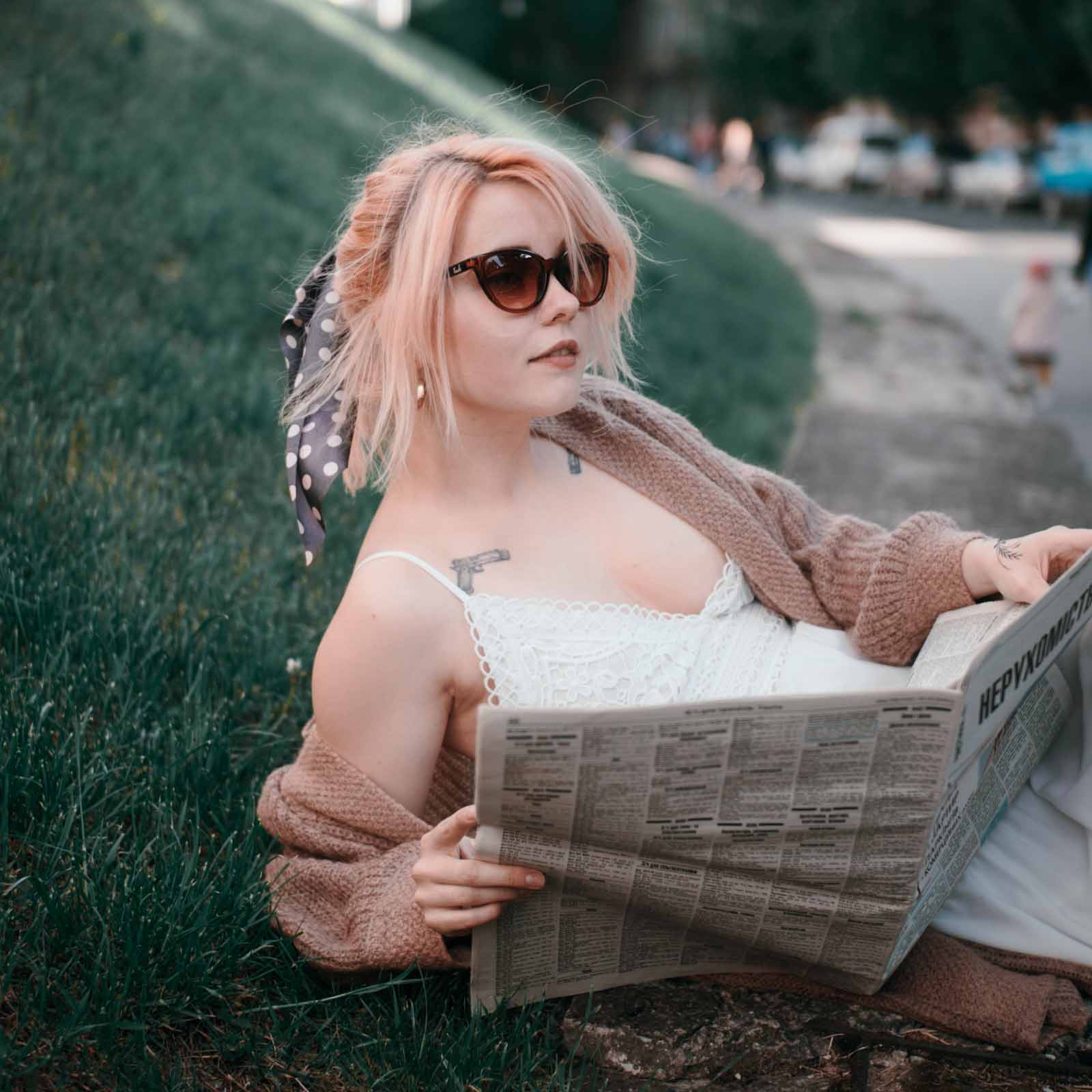 these lightweight sunglasses are ideal for every day use such as here where the model is reading a newspaper on a summers day